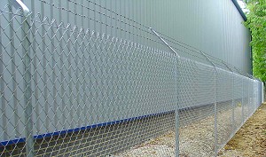 Chain Link Fencing on Angle Iron Posts with Barbed Wire